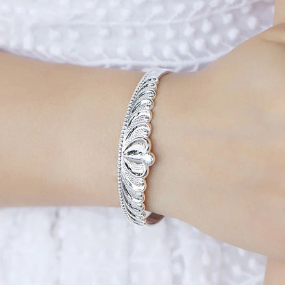 A close-up view of the elegant Crown Bracelet, showcasing its intricate crown-shaped design and shiny, rhodium-plated finish.