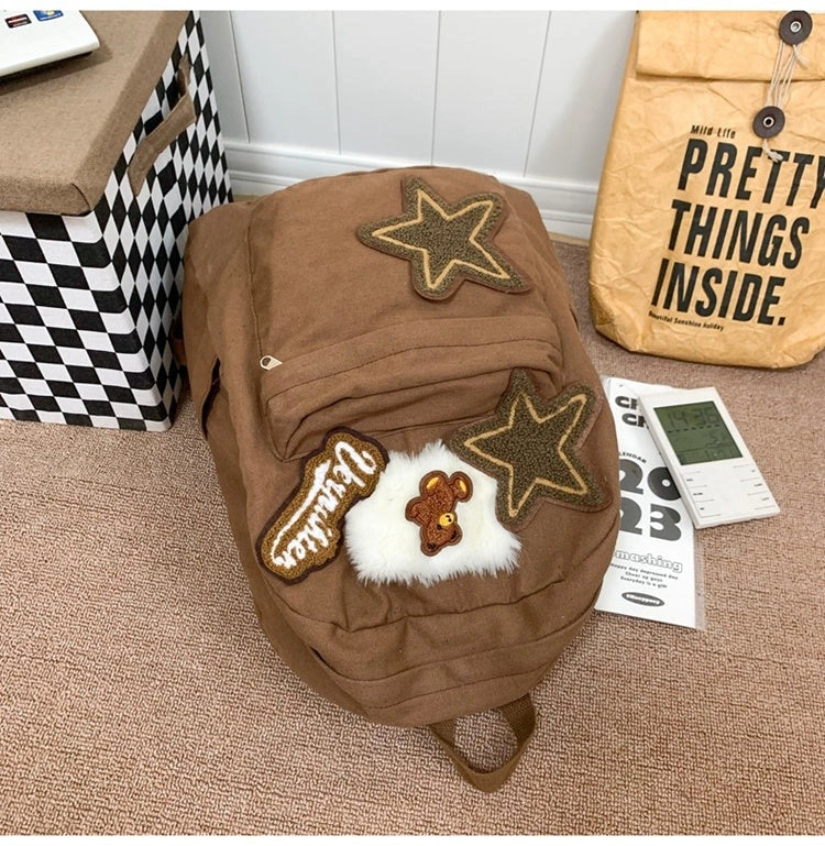 Brown canvas backpack with geometric patterns, ideal for female college students
