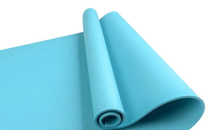 EVA composite fitness and yoga mat in blue, showing its texture and rolled edge next to a storage bag.