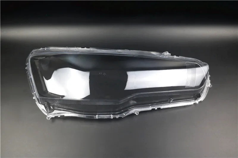 Transparent plastic car headlight housing cover with dimensions 50mm by 30mm by 20mm.