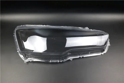 Transparent plastic car headlight housing cover with dimensions 50mm by 30mm by 20mm.