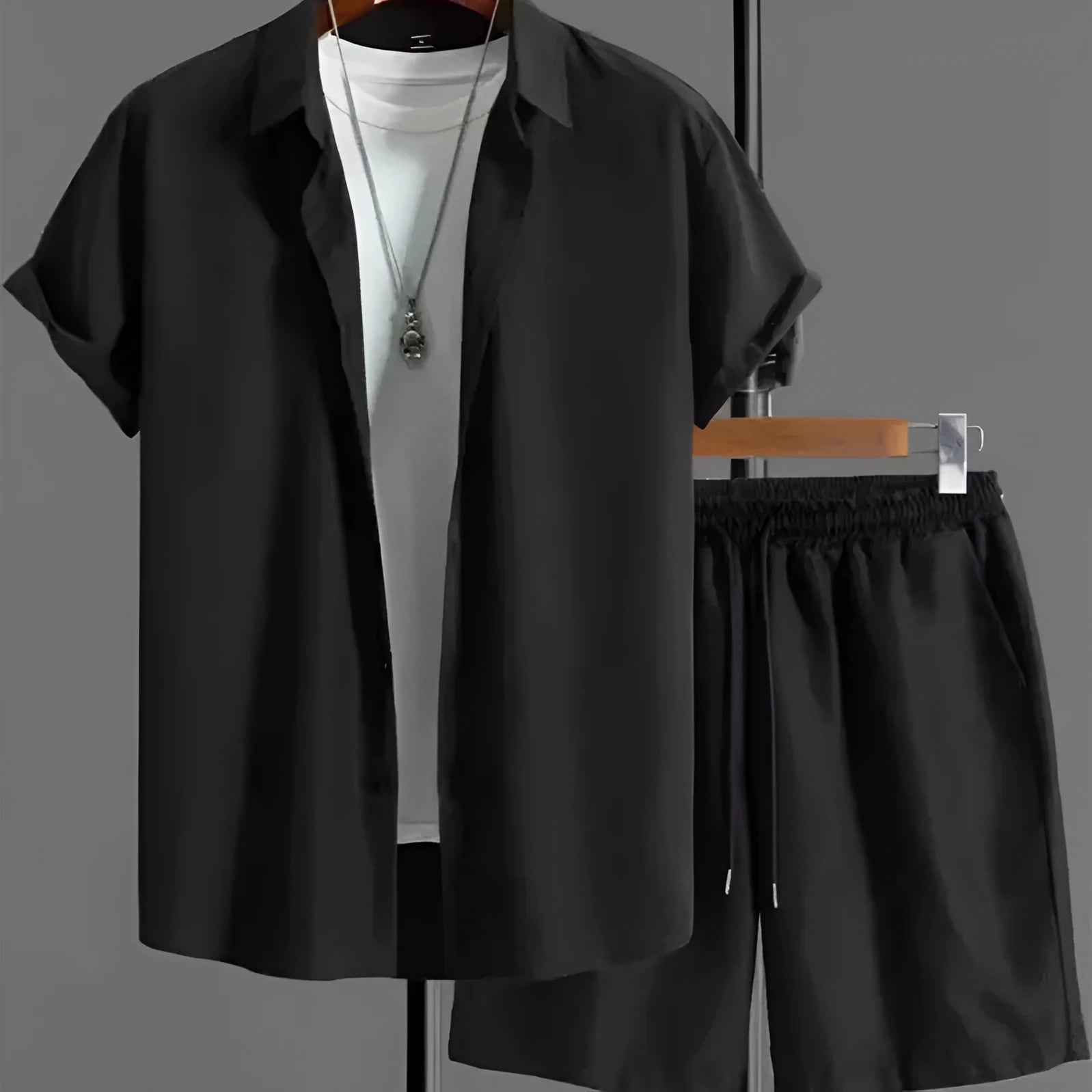 Man wearing a black and white jacquard short sleeve shirt and matching shorts suit set.