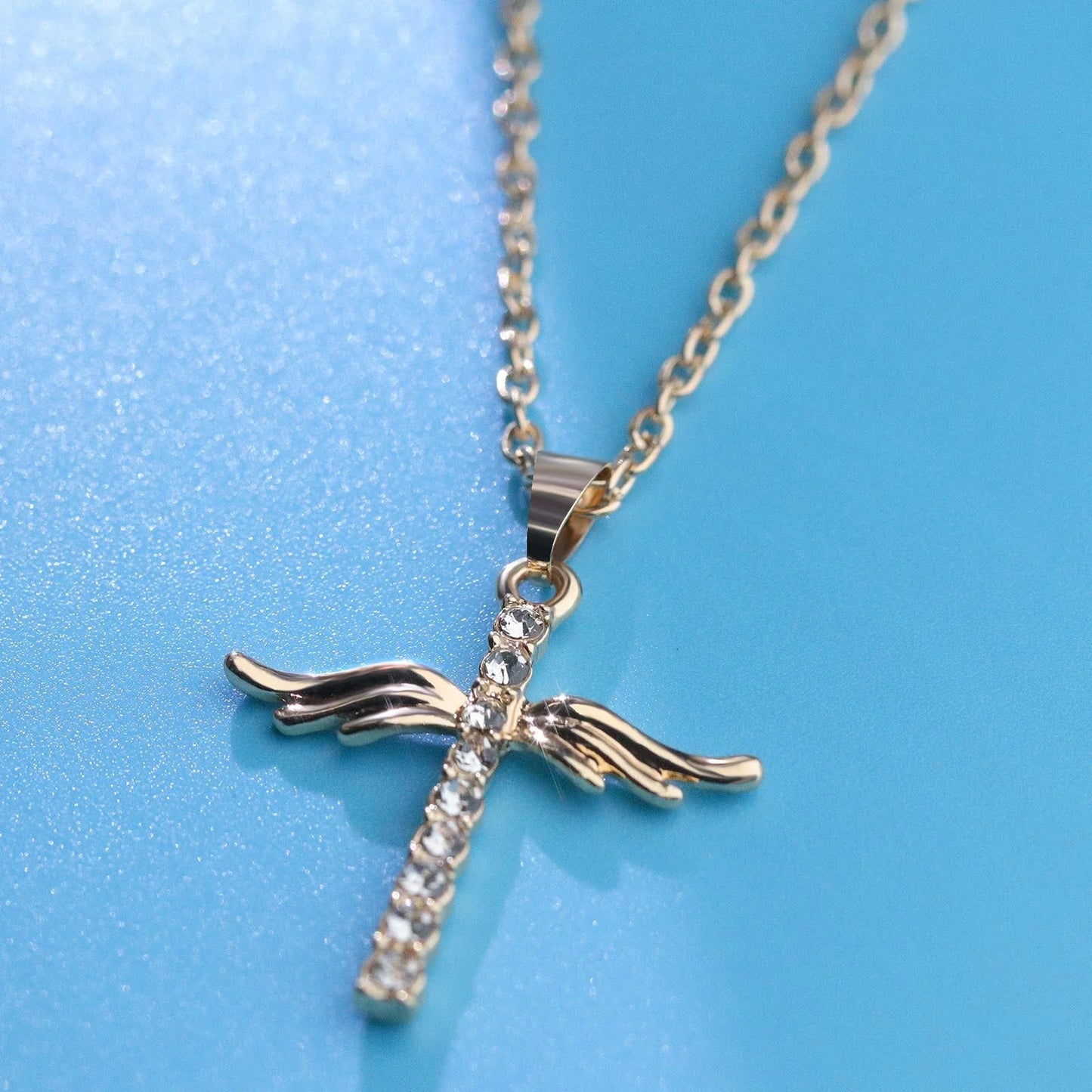 Elegant angel wings cross pendant necklace made of high-quality alloy in gold and silver tones, with adjustable chain length.