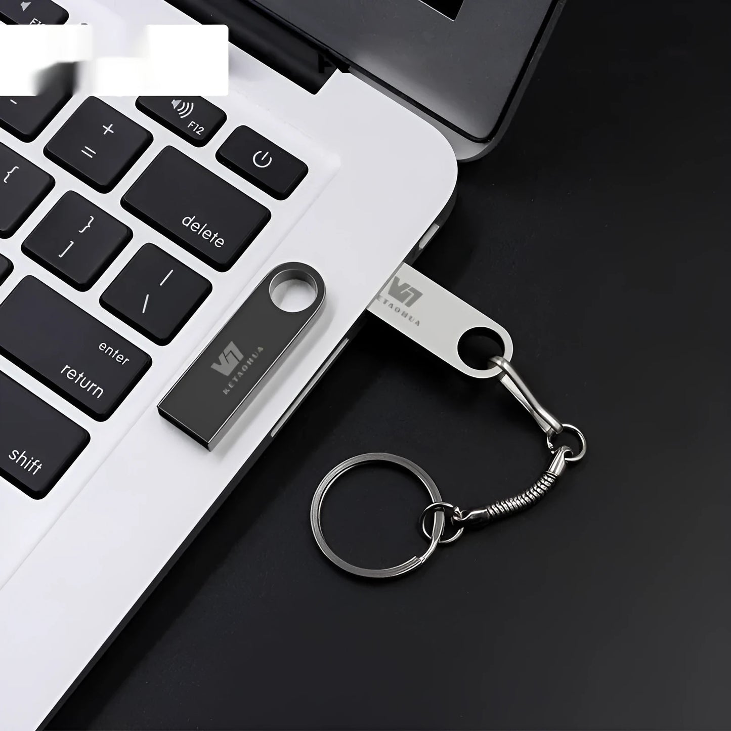 Custom silver metal car-shaped USB flash drive on a white background