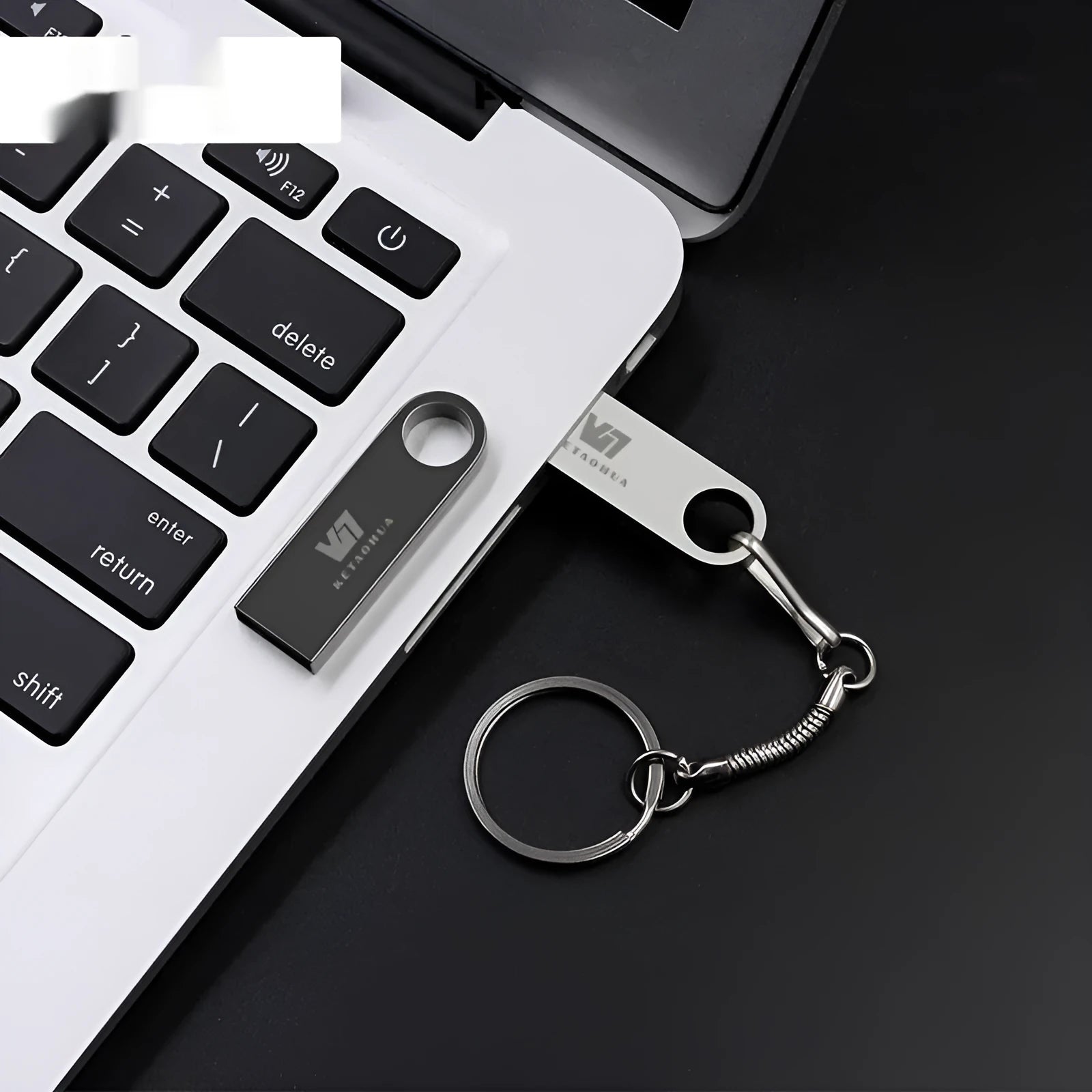 Custom silver metal car-shaped USB flash drive on a white background