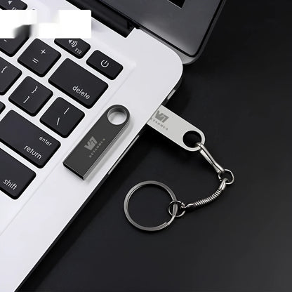 Custom silver metal car-shaped USB flash drive on a white background