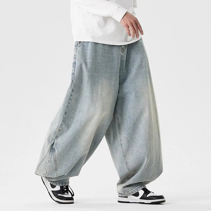 Men's plus-size light blue wide-leg baggy jeans on a neutral background.