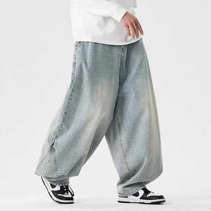 Men's plus-size light blue wide-leg baggy jeans on a neutral background.