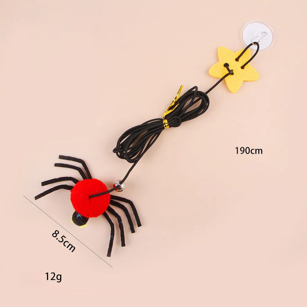 Red hanging door cat toy with elastic rope, feathers and spider-shaped bell mounted on door frame