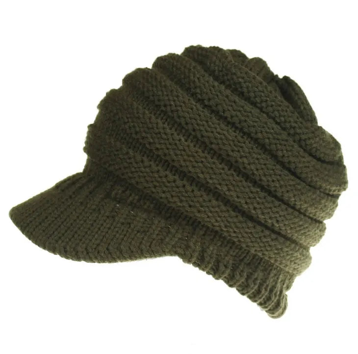 Women's acrylic knitted ponytail beanie in a solid colour, shown on a model with a ponytail.