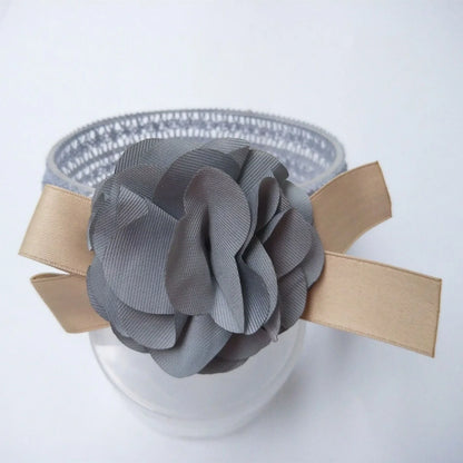 Baby lace headband with floral design in pink, grey, and rose red
