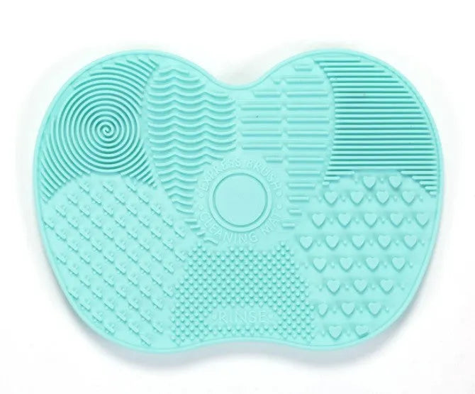 Silicone makeup brush cleaning pad, 15.5 x 12 cm, shown as a coloured brush cleaner mat for cleansing makeup brushes.