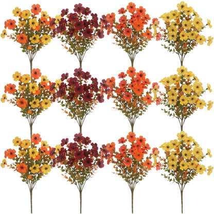 Artificial flower bouquet in autumn colours of red, yellow, and orange made from plastic and silk.