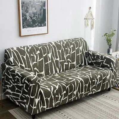 Printed stretchable sofa slipcover with geometric abstraction pattern on a three-seater sofa, showing tight fit and modern design.