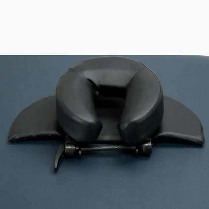 U-shaped black SPA facial massage pillow with adjustable height, shown with its zippered nylon carry case