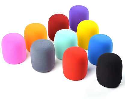 Four foam microphone wind shields in different colours for handheld stage microphones