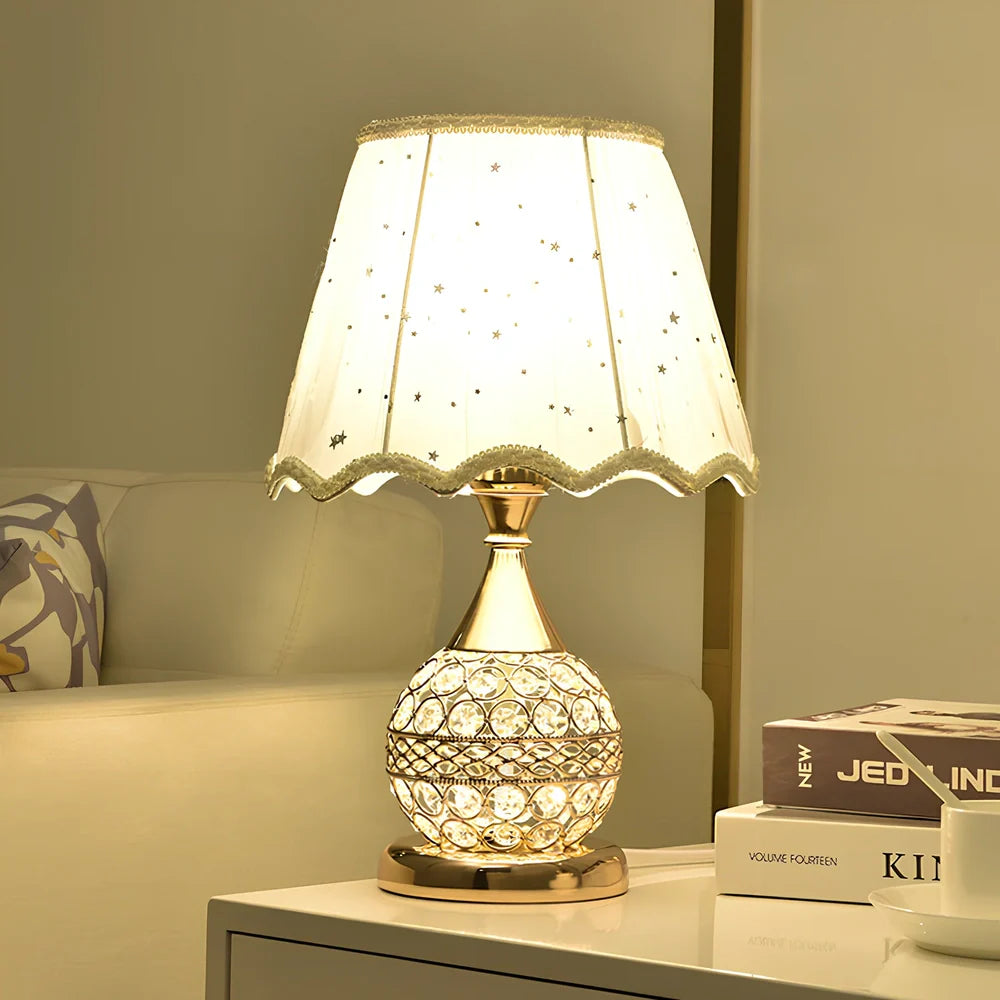 Gold crystal desk lamp with hand-cut facets and remote control on wooden surface