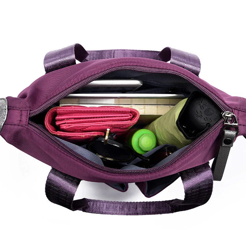 A fashionable and versatile ladies tote bag with multiple compartments and carrying options for the modern woman on the move.