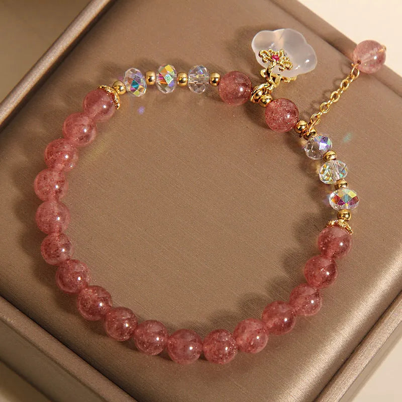 Women's strawberry quartz and white agate crystal bracelet with auspicious cloud charms on elasticated cord