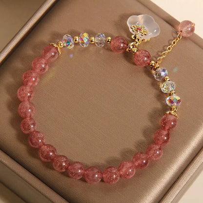 Women's strawberry quartz and white agate crystal bracelet with auspicious cloud charms on elasticated cord
