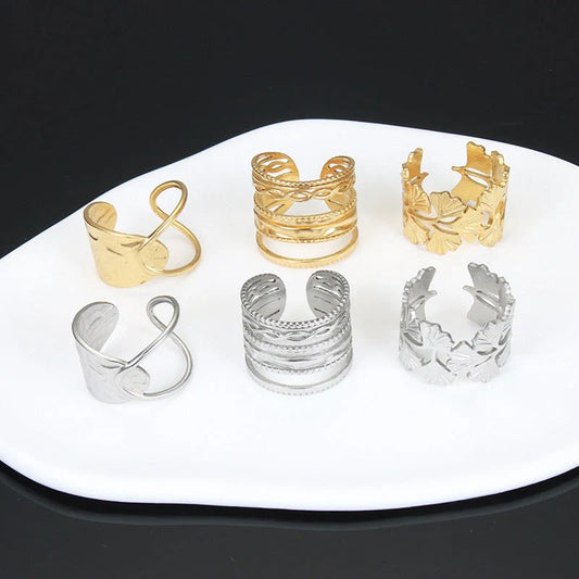 Adjustable stainless steel finger ring with unique charm designs in steel and gold finishes