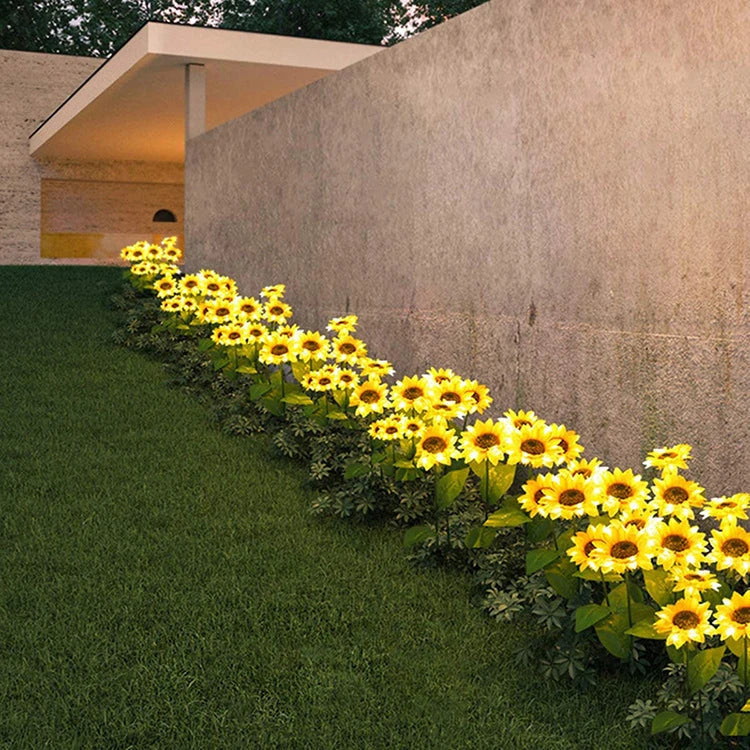 Elegant solar-powered sunflower lamps illuminating a serene outdoor garden pathway