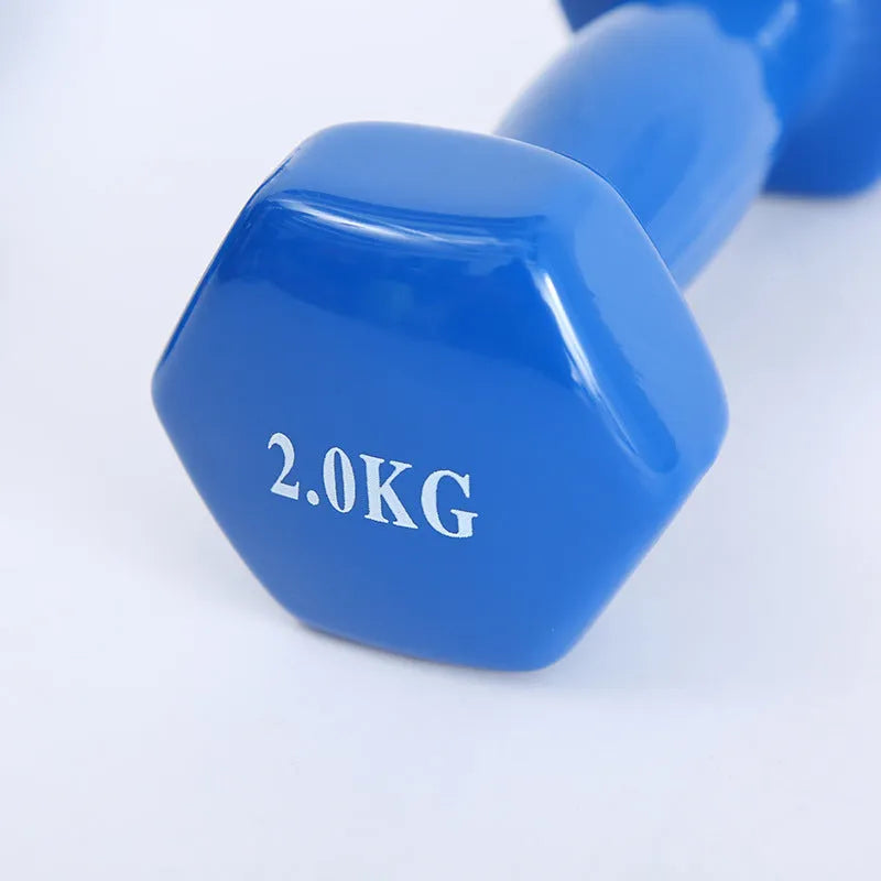 Set of bright coloured plastic-coated fitness dumbbells in 0.5kg, 1kg, and 1.5kg weights on a floor.
