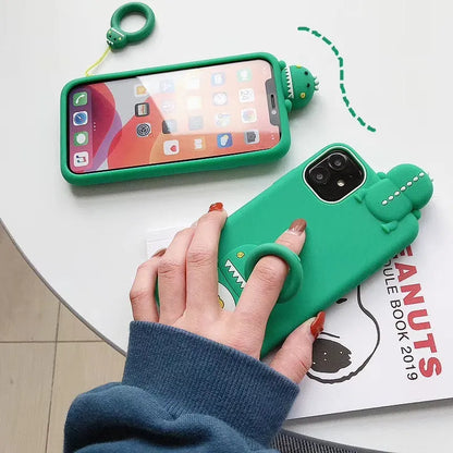 Green silicone iPhone case with animal cartoon design showing drop protection and waterproof features