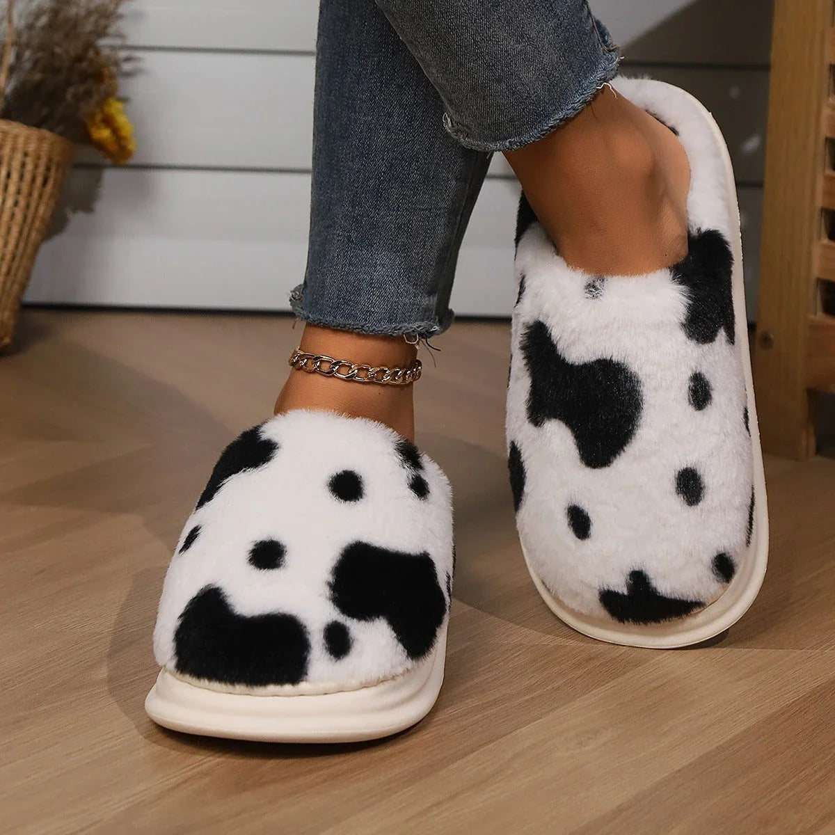 Cozy cow print plush slippers with soft, cushioned soles and non-slip outsoles for indoor comfort and warmth