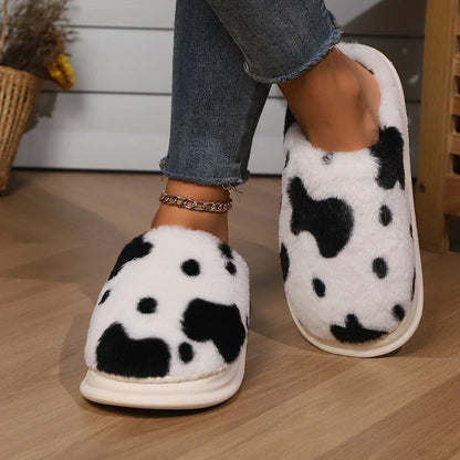 Cozy cow print plush slippers with soft, cushioned soles and non-slip outsoles for indoor comfort and warmth