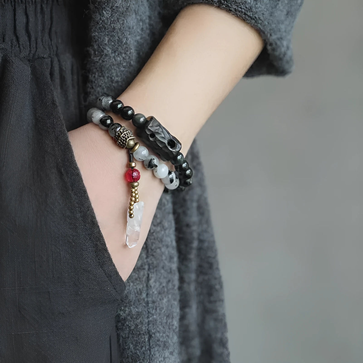 Ethnic black hair crystal bracelet with white tassel showing bending and lacing construction