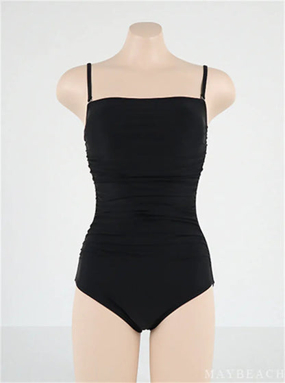 Sling style one-piece swimsuit with belly pleats in solid colour options