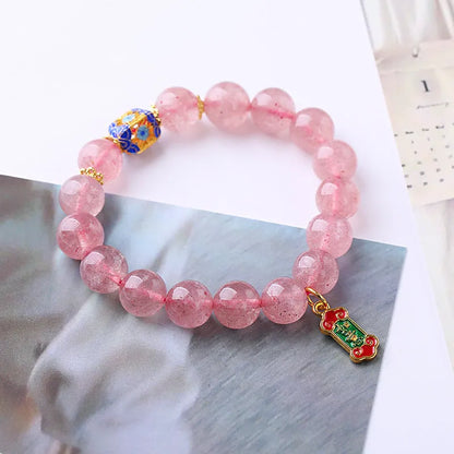 Pink crystal bracelet with Strawberry Quartz stones and Ruyi charm in hand-woven women's jewellery design