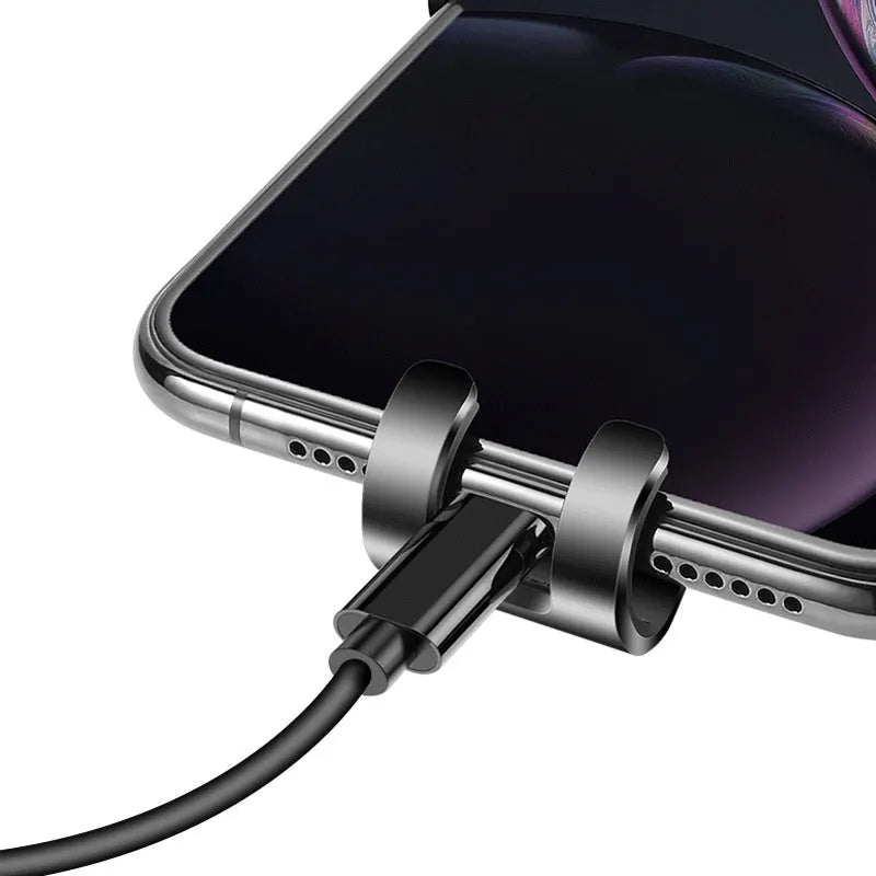Black S4 gravity mirror car phone holder clipped onto a car air vent, holding a smartphone.