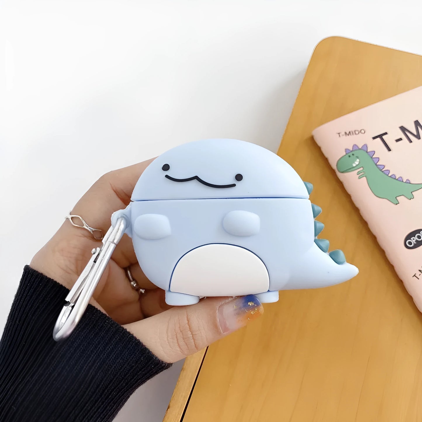 Blue silicone case with baby dragon design for Apple AirPods 1, 2, and 3 models.
