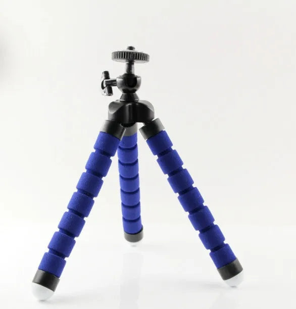 Black flexible octopus tripod with legs wrapped around a pole, holding a smartphone with a clip mount.