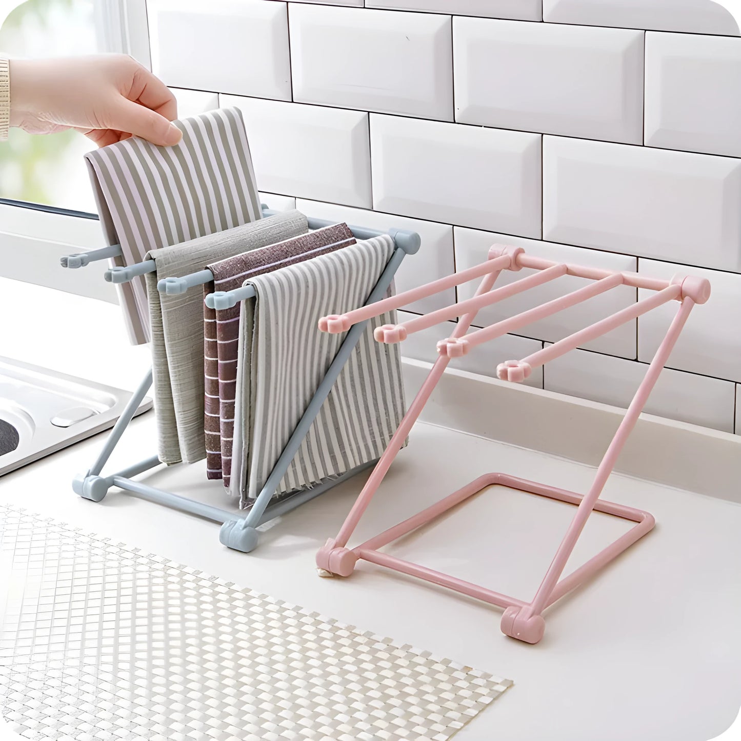 Foldable plastic dishcloth shelf organiser in light blue mounted on a wall.