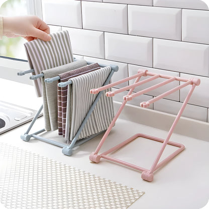 Foldable plastic dishcloth shelf organiser in light blue mounted on a wall.