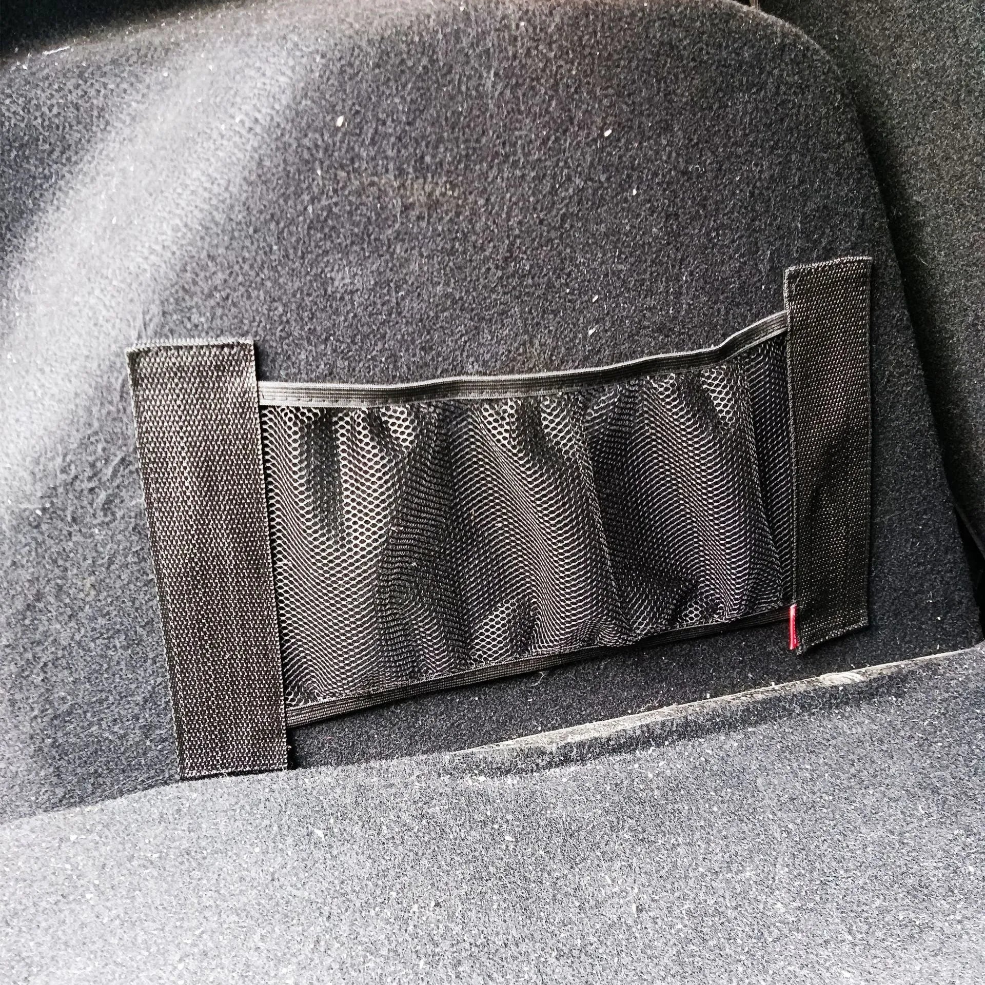 Elastic car boot storage net in polyester material for organising loose items in luggage compartment