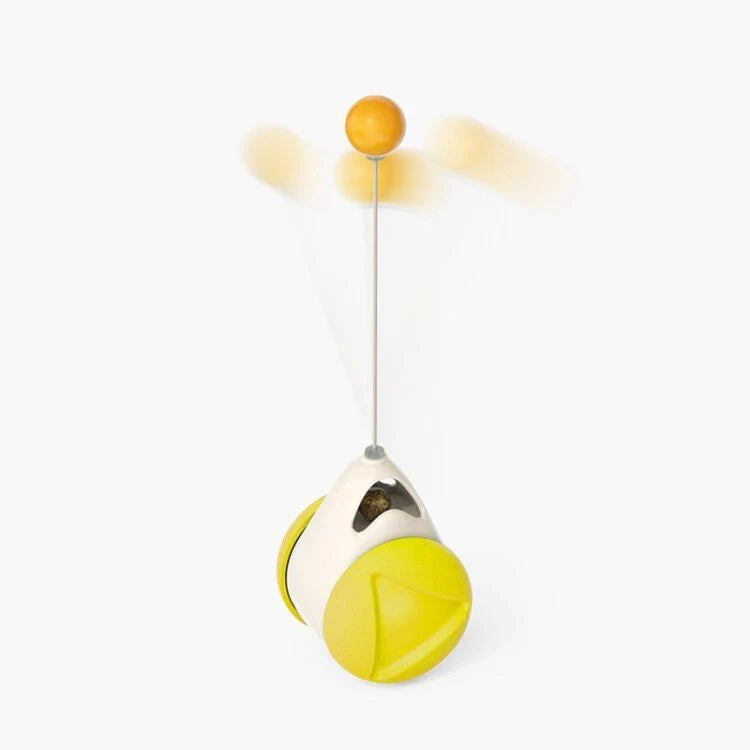 Cat playing with rotating windmill toy featuring luminous balls and suction base