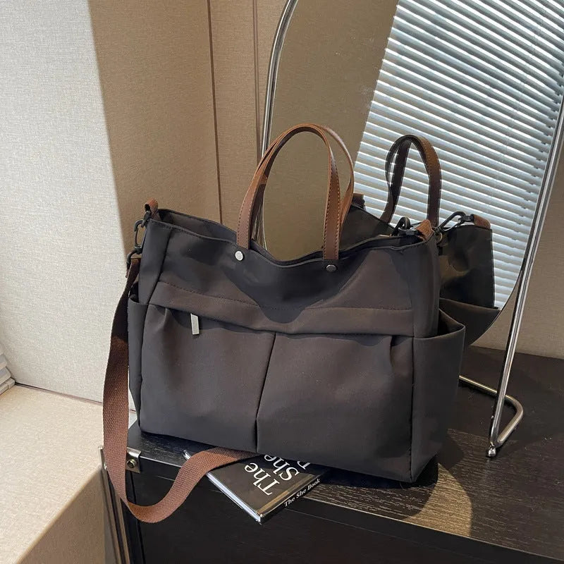 Nylon crossbody bag in five colours with 39x14x28cm dimensions and shoulder strap