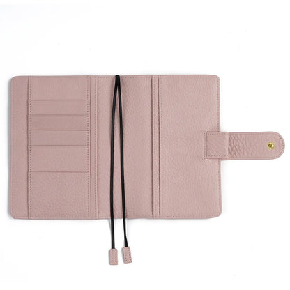 Close-up of a hand-embossed lychee pattern on an off-white A6 cowhide leather notebook with loose-leaf binding.