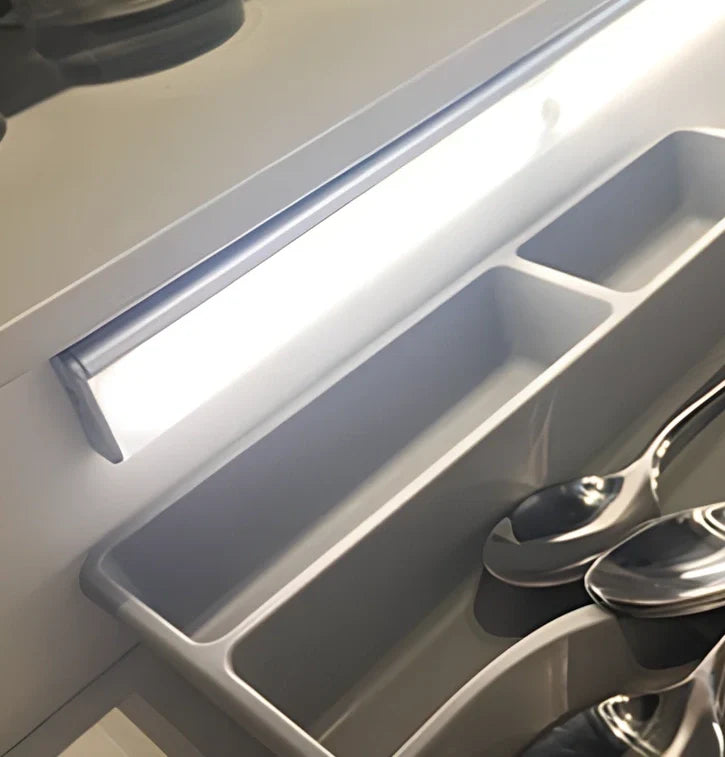 Wireless LED wardrobe light in 300mm size with motion sensor and charging pad, warm white glow, mounted on shelf
