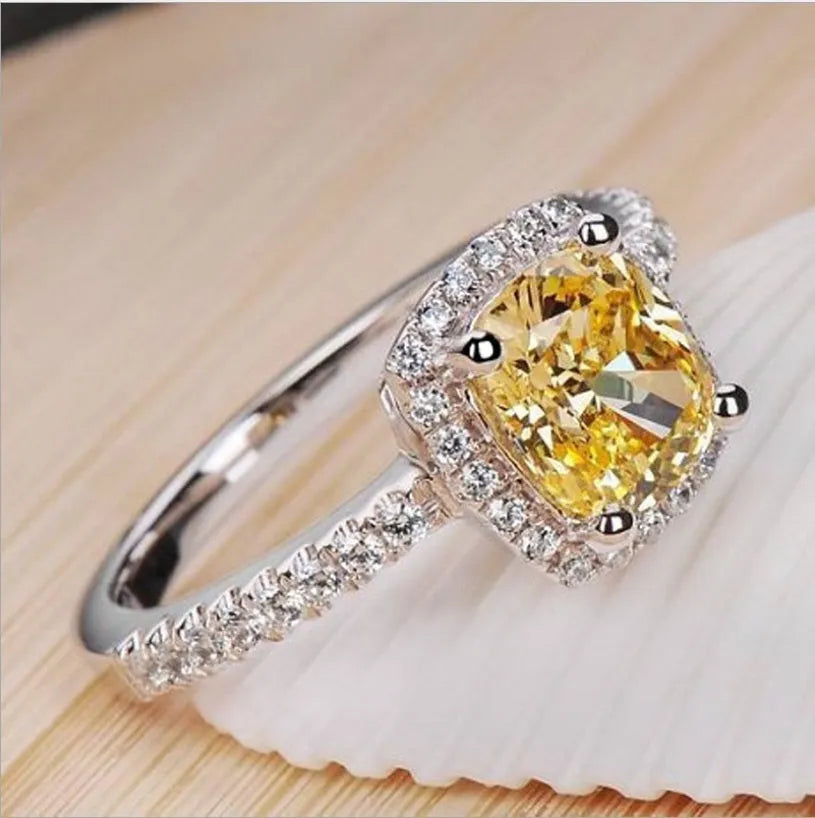 Women's silver colour alloy ring with artificial gemstone inlay and geometric design, bridal style.