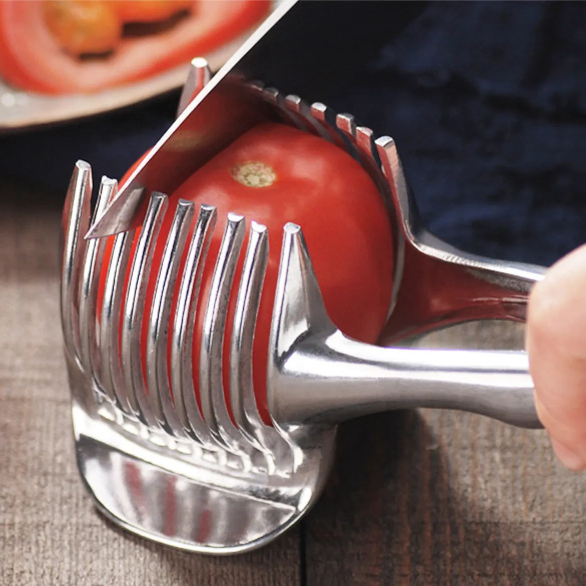 Silver plastic foldable lemon slicer kitchen gadget on a white background.