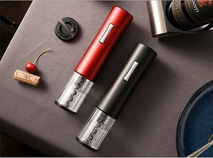 Black electric wine opener with transparent cover and aluminum foil cutter on wooden table