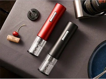 Black electric wine opener with transparent cover and aluminum foil cutter on wooden table
