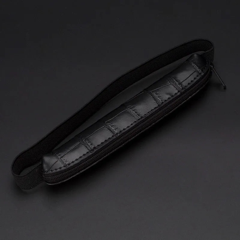 Long beige grey PU leather pencil case on a desk with pens