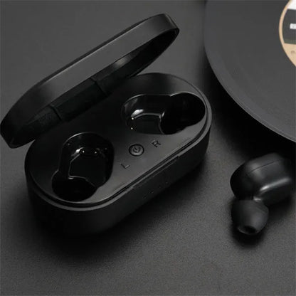 Black and white M1 wireless Bluetooth earbuds with a charging case on a neutral background.