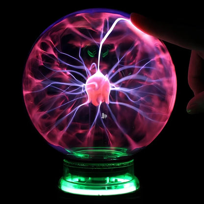 Plasma lightning ball with electrostatic induction showing colourful electrical discharges on glass surface